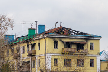 Old building with the roof and top floor damaged by the fire