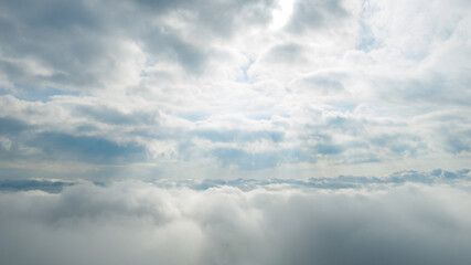 Panoramic view of beautiful blue sky with clouds and sun lights. View above clouds.