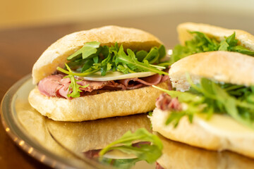 Prosciutto Italian sandwich with arugula and provolone cheese- side view