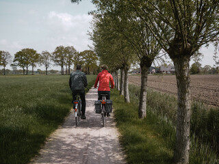 Cycling in Dutch countryside in agriculture fields, cycle lane
