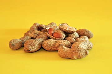 Groups of salted and baked peanuts. Unshelled and shelled peanuts and baked with salt. Isolated background.