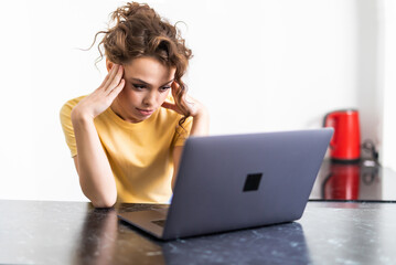 Frustrated sad woman feeling tired worried about problem sitting on sofa with laptop, stressed...