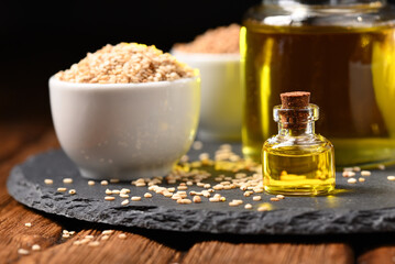 Sesame oil and sesame seeds on the slate plate.