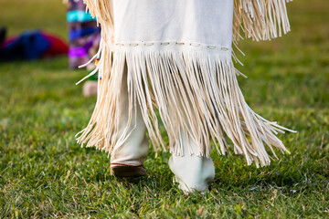 Selective focus of legs of unrecognized performer wearing a leather costume with frill as prop in...