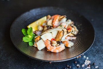 seafood salad or appetizer shrimp, mussels, squid and other ingredients top view copy space for text food background rustic pescetarian diet