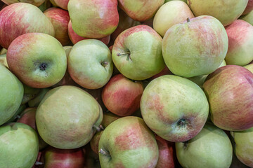 background of fresh juicy apples on the market