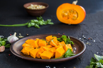 Beautifully chopped pumpkin salad, herbs, and ingredients for the dish. Creative atmospheric decoration