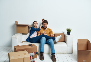 Fototapeta na wymiar Cheerful young couple in an apartment boxes with things moving 