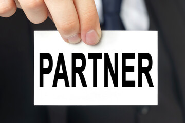 Businessman shows a card with the text PARTNER