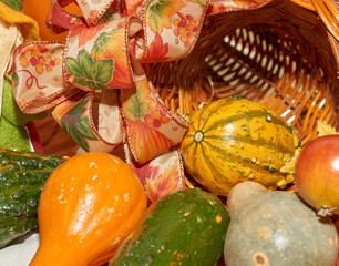 Halloween display with gourds, scarecrow, pumpkin, ribbons and gourd wicker basket