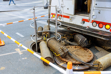Open manhole with few cables connection internet using fiber optic cable for fast internet...