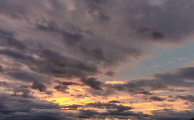 Naklejka na ściany i meble fiery orange, pink stormy sky and alarming storm clouds at dawn