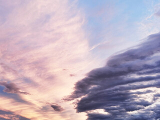 fiery orange, pink stormy sky and alarming storm clouds at dawn