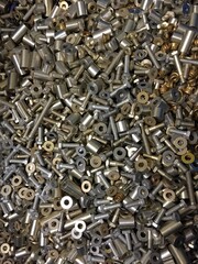 Various metal bolts, washers, nuts as background