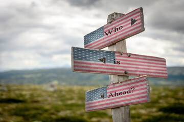 who is ahead text on signpost with the american national flag.