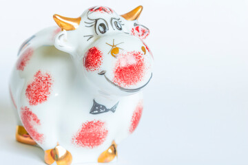 Porcelain figure of a bull, on a white background. New year of the bull