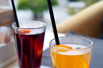 Mulled wine in tall glasses in a cafe. Warming drink with fruits and spices..