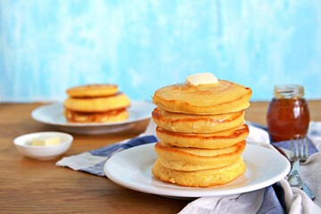 Cornmeal pancakes on a white plate.