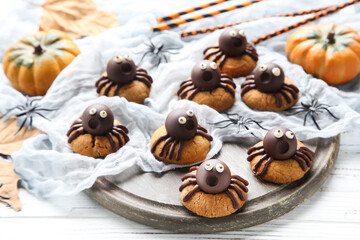 Fototapeta na wymiar Halloween cookies with chocolate spiders on wooden background