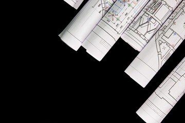 Architectural project, drawings on a dark background. Rolls of project drawings