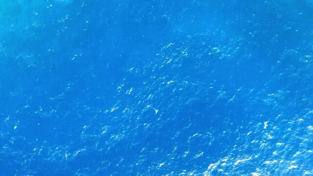 Aerial top down view from high altitude of blue azure turquoise sea water