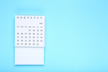 Paper calendar page on blue background