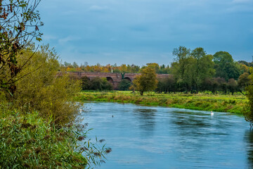 Fototapeta na wymiar A view along the River Itchen towards the Hockley viaduct at Winchester, UK in Autumn