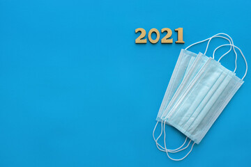 Coronavirus corona virus prevention surgical masks for infection spread protection. and numbers 2021 New year. Сoncept of the coronavirus pandemic during the holiday. Blue background, copy space