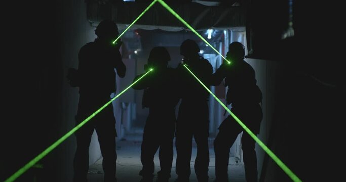 SWAT team with laser sights in dark corridor