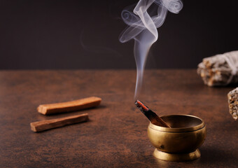 The smoke of burning palo santo stick .
