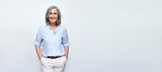 Smiling beautiful mature business woman standing isolated on white background. Older senior...