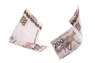 200 reais banknotes, bank notes falling on isolated white background. Two hundred reais from brazil, selective focus. Fall, inflation and loss concept
