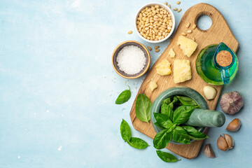 Ingredients for cooking italian pesto sauce on concrete background