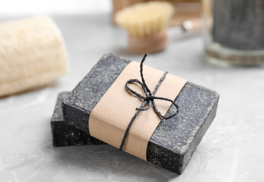 Natural tar soap on light grey table, closeup