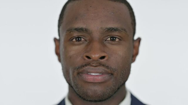 Close up of Serious Young African Man, White Background 