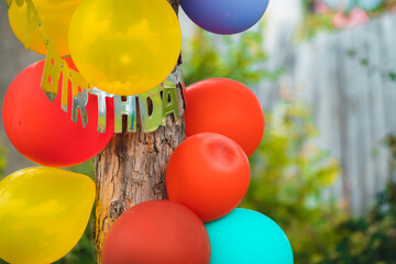Fototapeta na wymiar Party balloons attached to a pine tree