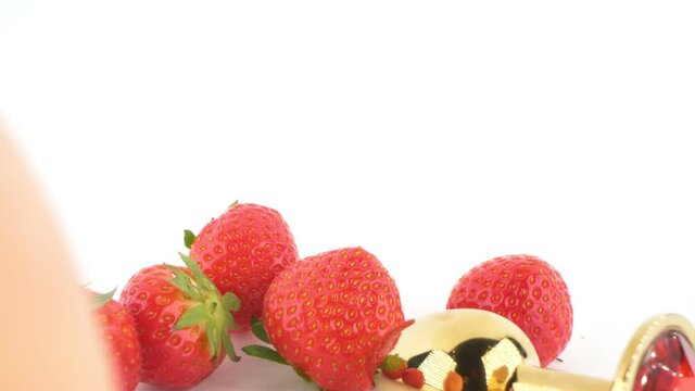 close-up. peach, strawberry and butt plug isolated on white background.