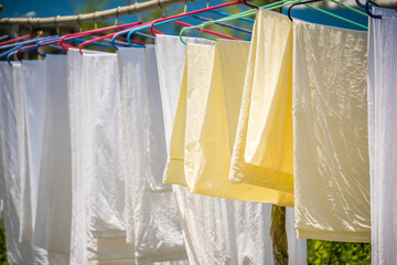 washed and clean bedsheets hanged to dry