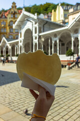 The famous Carlsbad wafers, CZ: Karlovarske oplatky, originated in 1867. Hand holding traditional...