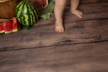 the child pulls out the bones from the watermelon. child eats watermelon