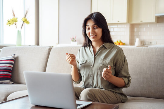Young adult indian woman distance teacher, tutor, job applicant talking by video conference call using laptop computer work from home office. Virtual chat meeting, web counseling, remote job interview