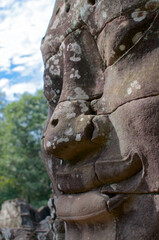 Fototapeta na wymiar Smiling stone face at Bayon Temple in Cambodia