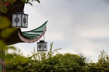 House roof with lanterns on cloudy sky