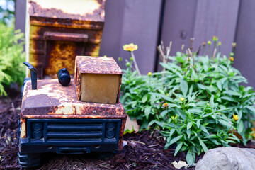 old toy truck in the garden with flowers