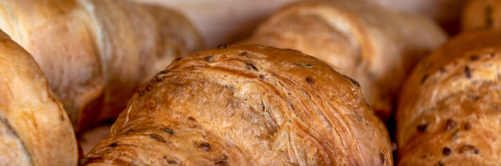 Baner of fresh croissants removed from the oven