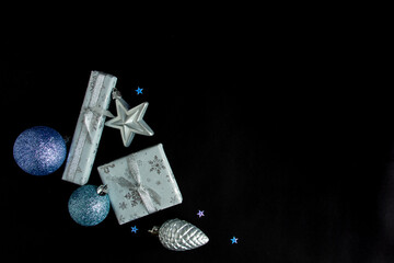 beautiful bright Christmas composition of New Year's toys on a black background, postcard.Flat lay, copy space, top view