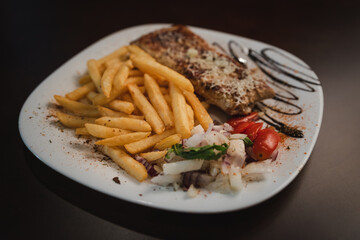 roast meat with cheese and salad on a plate and salad on a plate