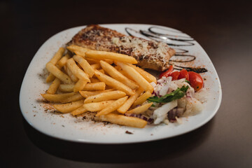 roast meat with cheese and salad on a plate and salad on a plate