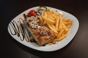 roast meat with cheese and salad on a plate and salad on a plate