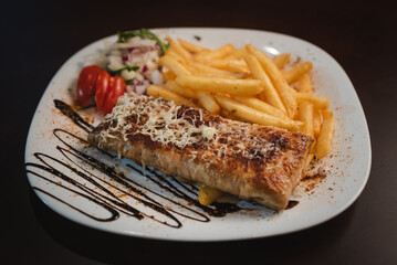 roast meat with cheese and salad on a plate and salad on a plate